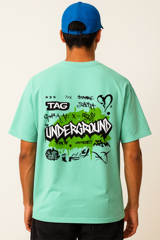 Men's oversized graphic t-shirt in mint green featuring graffiti-style underground print on the back
