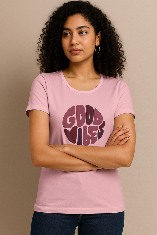 alpha hue women's classic t-shirt in light pink with good vibes graphic worn by woman with curly hair