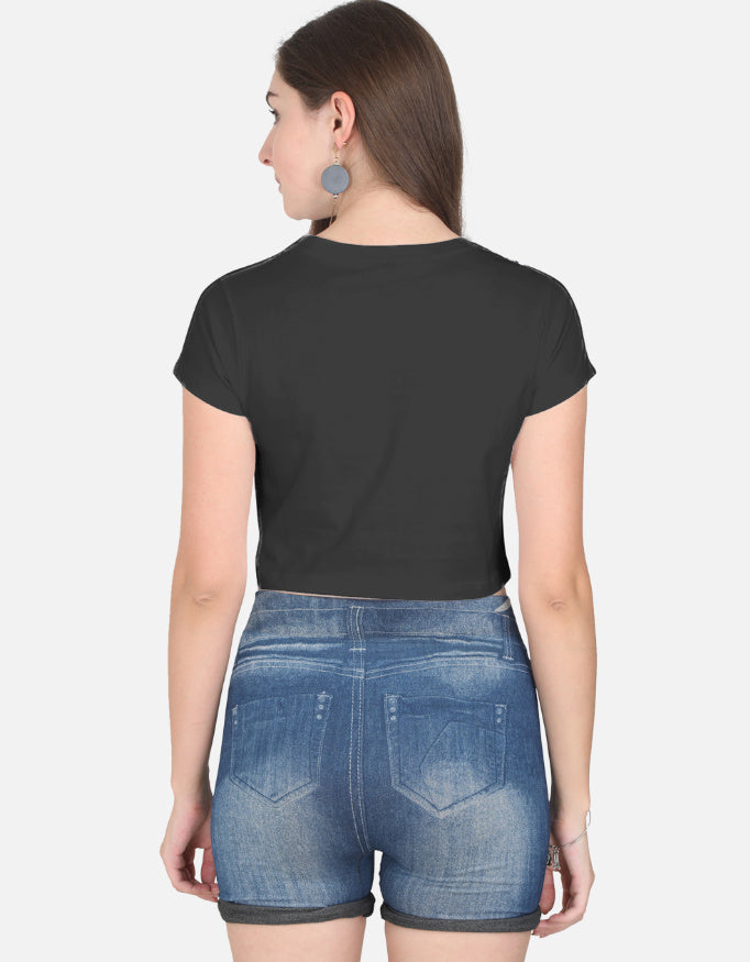 Back view of woman wearing black cute panda crop top paired with denim shorts