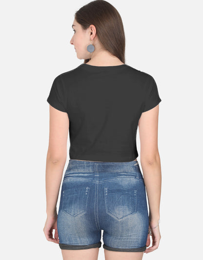 Back view of woman wearing black cute panda crop top paired with denim shorts