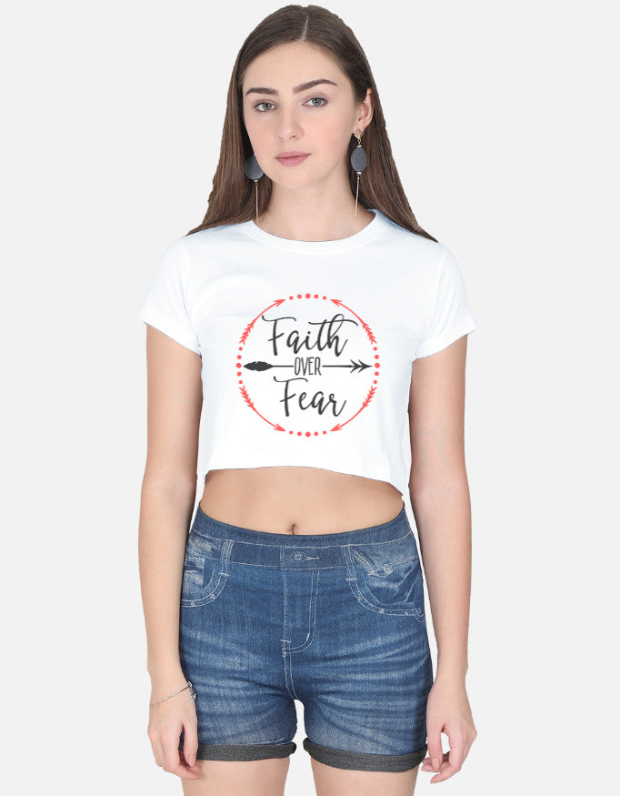White faith over fear crop top by alpha hue worn with denim shorts by a woman