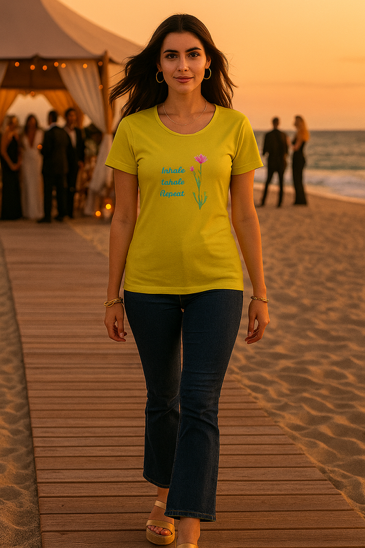 alpha hue yellow ladies t-shirt with flower graphic worn by woman on beach boardwalk at sunset